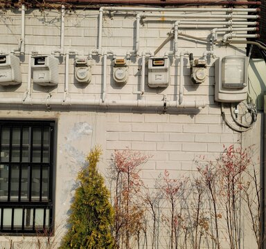Urban white wall with pipes, meter and autumn leaves in Jongno Seoul