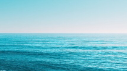 Fototapeta premium Serene Blue Ocean Waves Under Bright Sky with Calm Horizon on a Tranquil Day in Tropical Paradise