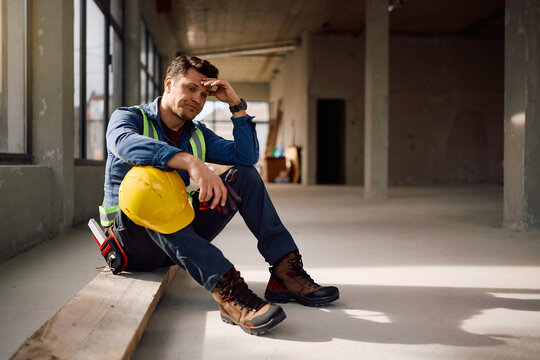 Worried construction worker thinking of his problems at work.