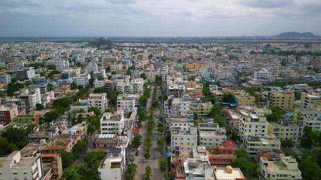 High-angle view revealing a sprawling cityscape with colorful residential houses and apartment buildings in Vijayawada, India.