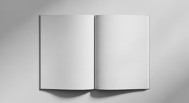 A grayscale image of an open book with blank white pages on a gray background with shadows
