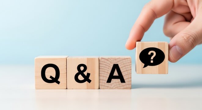 Hand placing a wooden block with a question mark next to q a letters aspect ratio 16 9