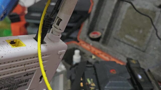Close-up of a technician performing fiber optic fusion splicing using a precision machine to connect optical cables. The footage highlights high-speed internet infrastructure
