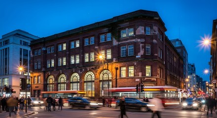 Fototapeta premium Evening Cityscape: Historic Brick Building and Street Scene with Traffic and People