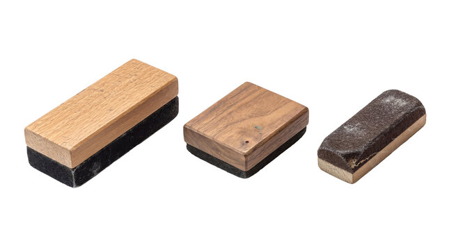 Photograph of three traditional blackboard erasers with wooden tops and felt bottoms.