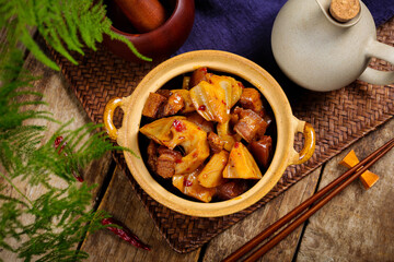 Fototapeta premium Braised Pork Belly with Lotus Root in Rustic Pot