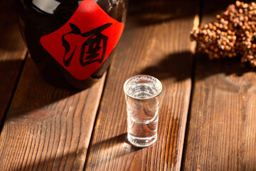 Chinese baijiu shot glass on wooden table © LuuDieuThanh