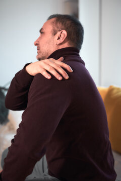 Man with neck, muscle, back and sciatica pain at home.