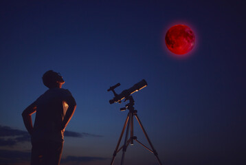 Fototapeta premium Amateur astronomer observing Lunar eclipse with a astronomical telescope.