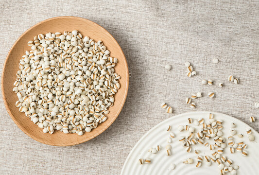 Raw Coix Seeds in a Wooden Bowl