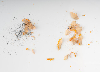 Naklejka premium Sharpening pencils isolated. Yellow wooden graphite pencils with erasers, pencil shavings