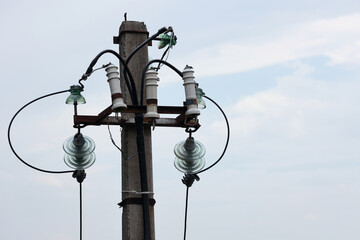 Obraz premium High voltage glass and ceramic insulators on a power pole