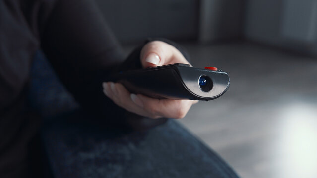 Person Holding Black Remote Control Device in Dark Room, have fun and enjoy