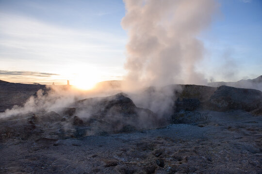 Powerful geyser steam at sunrise in sol de manana geothermal field