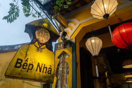 Hoi An, VIETNAM &ndash; 20 November 2025: A Bep Nha restaurant sign and lanterns hang outside a building in the historic UNESCO protected city of Hoi An.