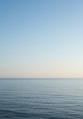 Obraz premium Minimalist, serene image of a calm sea meeting an empty sky at a smooth horizon line, perfect for copy space, minimal, aesthetic, design