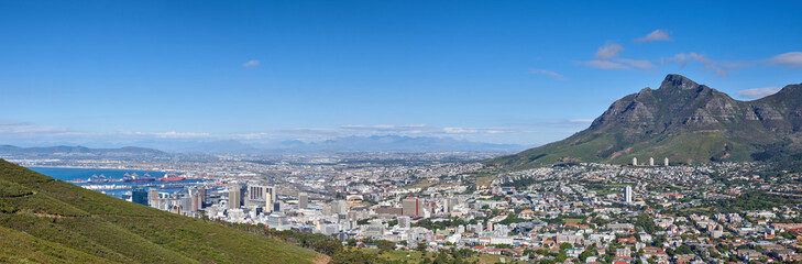 Fototapeta premium Mountains, ocean and city with environment, landscape and location for tourism, banner and blue sky. Empty, outdoor and natural beauty with hills, beach and destination for summer holiday and space
