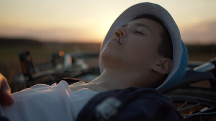 Teen Relaxing Outdoors at Sunset with Bicycle, have fun and enjoy