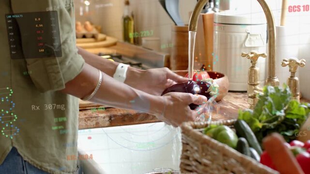 Reaching into basket, woman in olive top turning on faucet at sink, preparing eggplant for cooking