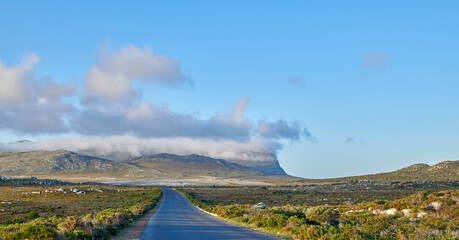Naklejka premium Travel, mountain and landscape with road in nature for environment, holiday destination and journey. Summer, sustainability and ecology with highway street in countryside for path and outdoor