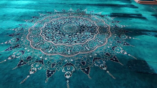Beautiful close up of a teal carpet with intricate patterns and designs in a mosque, showcasing traditional Islamic art and architecture with soft lighting