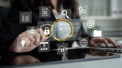 Fototapeta premium A professional woman operates a digital interface focused on secure login processes, showcasing modern technology and business efficiency in an office setting. Gantry