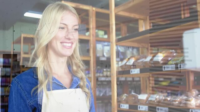 Bakery worker smiling and showing loaves while camera tightening starting overlays obscuring her