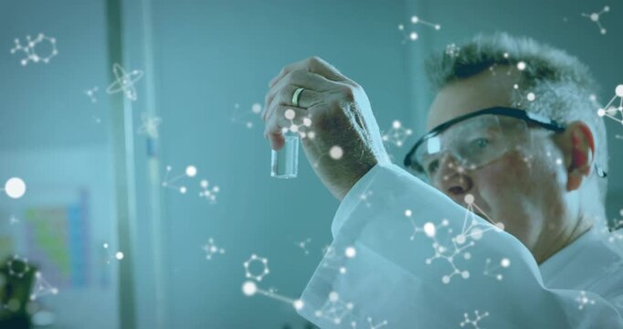 Senior researcher raising vial to eye level, rotating, tilting while inspecting sample for analysis