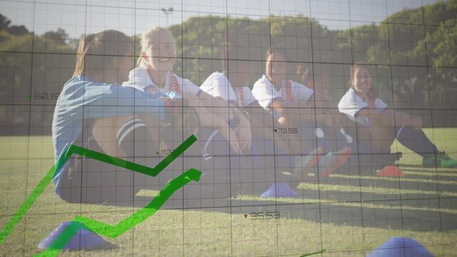 Women players sitting during soccer training, data lines sweeping and charts rising over them