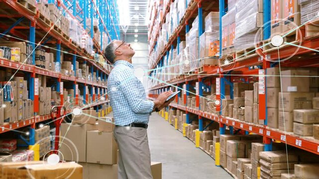 Warehouse worker tapping tablet in long aisle, activating animated nodes and mapping inventory