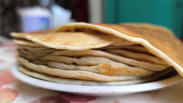 stack of pancakes in a plate on the table.