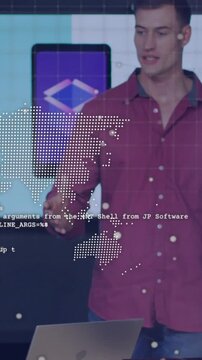 Vertical video: Host pointing to laptop and initiating tech demo code and map floating over desk
