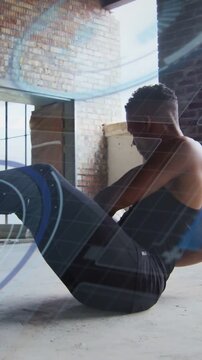 Vertical video: Male athlete initiating twist holding ball, training core, HUD tracking rotation