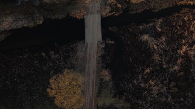 Top Down Aerial Over Wooden Herringbone Bridge at Golden Hour