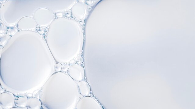 Clear liquid bubbles macro abstract water texture transparent fluid surface minimal clean background soft light close up science cosmetic serum texture.