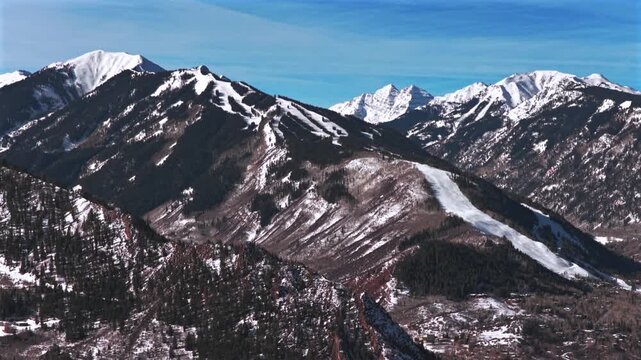 Highlands Bowl Pyramid Peak winter bluebird morning Aspen Mountain AJAX Aspen Highlands Ski resort aerial drone Colorado ski trail Maroon Bells Wilderness blue sky fresh snow chairlift circle left
