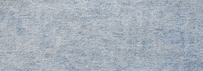 High quality seamless light blue denim fabric texture background with detailed diagonal weave...