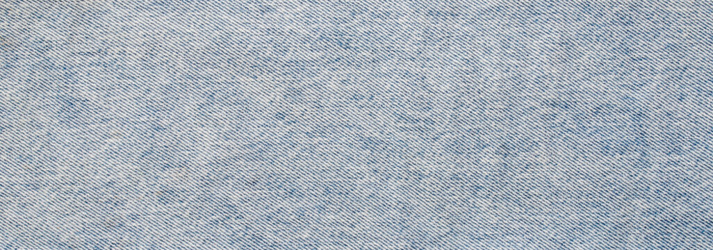 High quality seamless light blue denim fabric texture background with detailed diagonal weave pattern for fashion apparel design and textile mockup