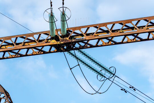 View of power lines stretching across a light blue sky, creating a network of geometric shapes against the airy expanse, Kyiv, Kyiv city, Ukraine.