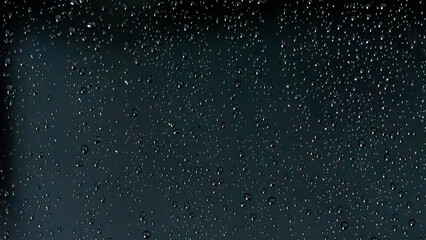 Fototapeta premium realistic rain drops on a dark window pane during a storm at night perfect for moody atmospheric backgrounds