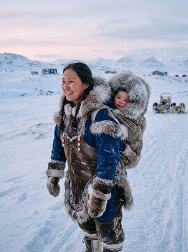 Inuit mother carrying baby in amauti traditional clothing