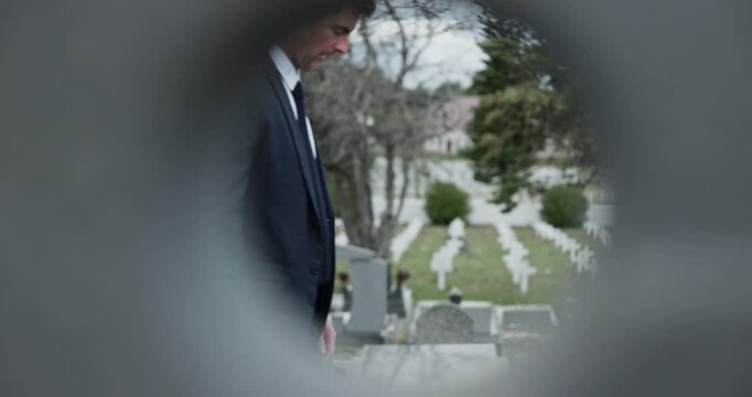 Funeral, family and people with walk in graveyard for memorial service, burial and perspective for mourning. Profile, grief and lens at gravestone with procession, death and compassion or remembrance
