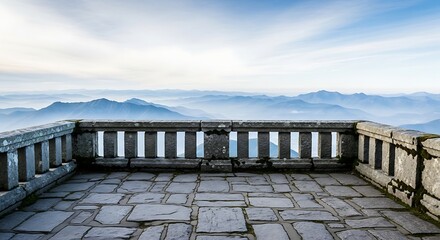 Fototapeta premium Stone balcony overlooking a misty mountain landscape at sunrise