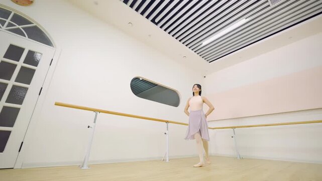 A graceful ballerina ballet dancer training in studio perform elegant pose dance elements positions in class for wellness, practice routine rehearsal or balance in bright studio, sport workout