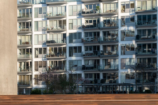 Modern apartment facade architecture with stacked balconies and window pattern in Copenhagen Denmark