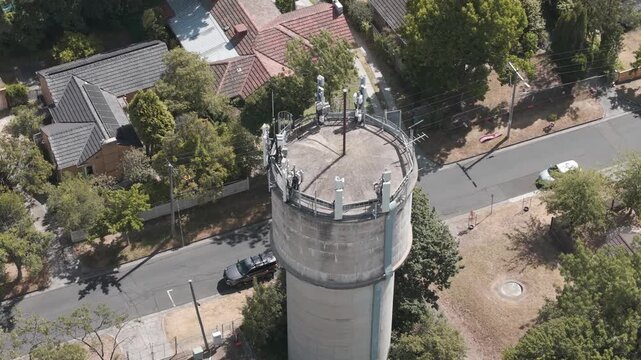 Stunning aerial footage captures the Karen Reece water tower amidst a calm suburban setting. The rotating drone video provides a unique perspective on the architecture and landscape.
