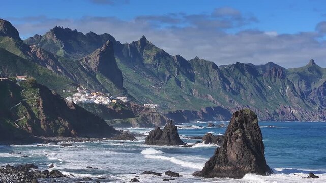 View of the wild Benijo beach at high tide. In the distance, the village of Almaciga. Northern part of Tenerife. Canary Islands.
