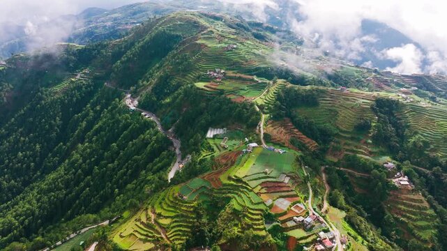Aerial view of rice terraces emerging through clouds in Benguet highlands