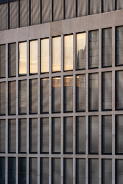 Modern corporate office facade with windows featuring grid texture geometry pattern and symmetry as clean architecture background for design