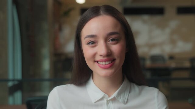 Business portrait Caucasian businesswoman looking at camera toothy smiling carefree attractive woman female girl student indoors in office posing joyful formal lady working in bank marketing agency